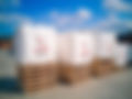 Image of Six Star Bulk Bag's white bulk bags with four loop construction, neatly stacked on wooden pallets. These bags are designed for secure and efficient handling, suitable for various industries. The clear blue sky in the background highlights the outdoor setting, showcasing Six Star Bulk Bag's commitment to quality and durability since 1986.