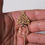 Thumbnail: Small gold Algerian fibula pin with hand of Fatima.