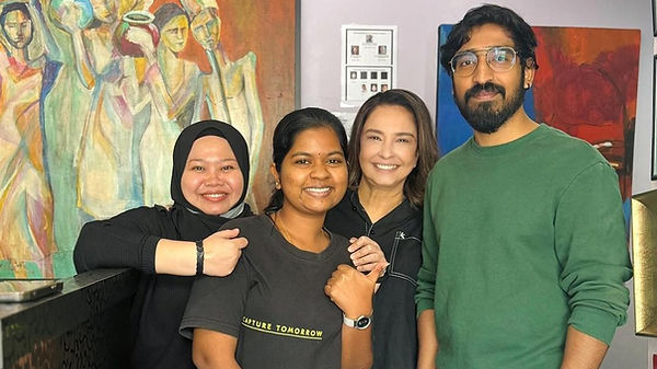 Dr Kamsiah dental specialist clinic team smiling together inside the clinic