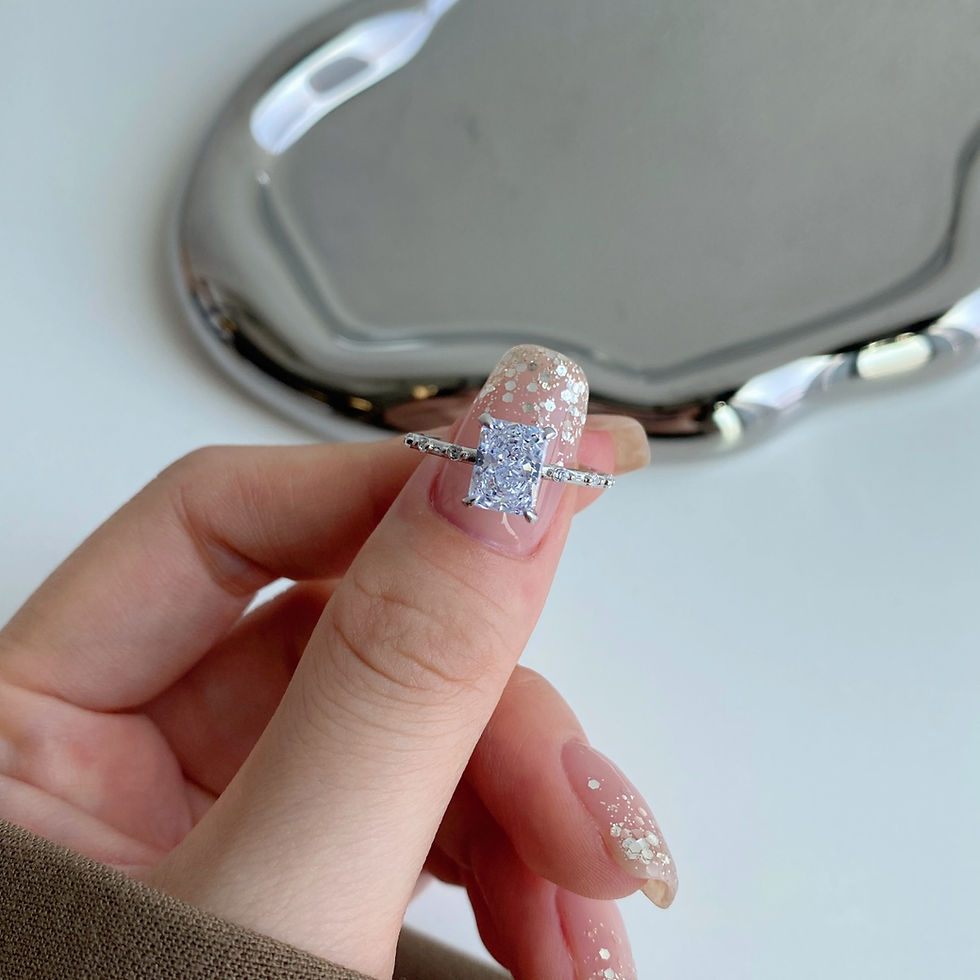 Thumbnail: The Brianna Ring with a radiant cut diamond on a hand