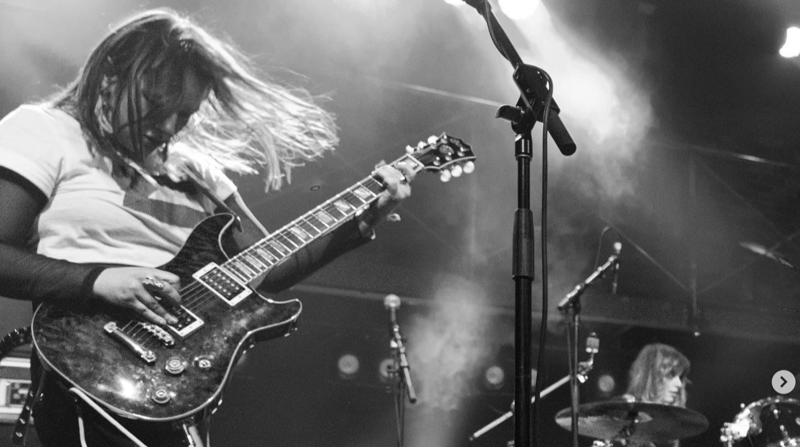 Image of the lead guitarist of the band SLUG playing.