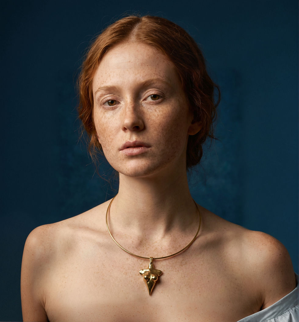 Model wearing female body choker necklace in gold inspired by the female form