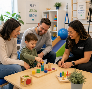 Parents and therapist watching a child play with colorful peg toys.