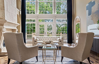 Elegant living room with large windows, plush seating