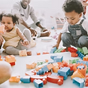 Children playing with colorful building blocks on floor