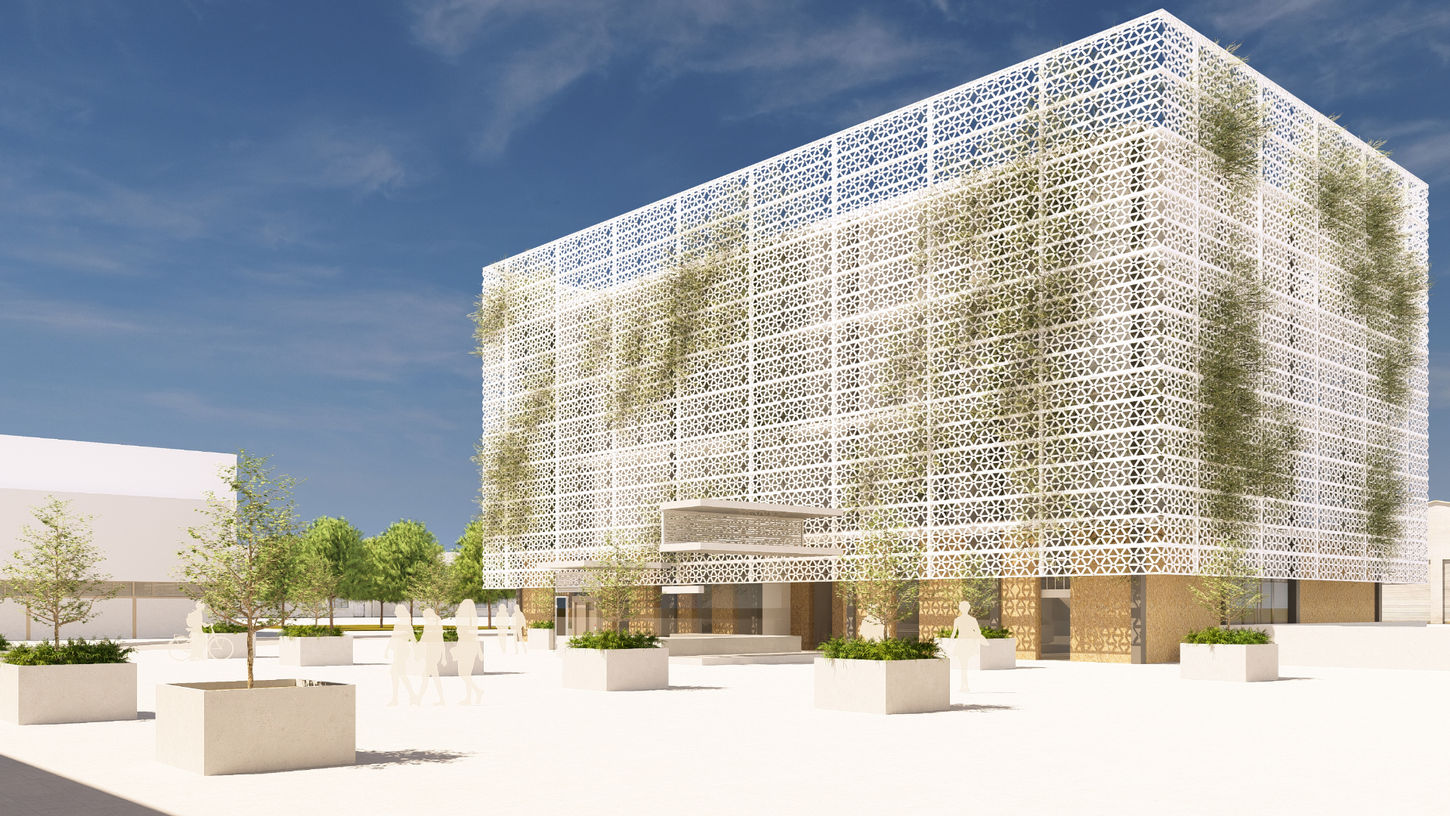 Edificio institucional con fachada perforada y plaza pública ajardinada diseñado por Genovés Calleja Arquitectos.