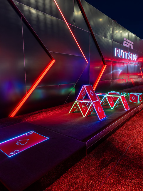 ESPN Putt Stop interactive mini-golf activation at Formula 1, featuring neon casino-themed obstacles, LED-lit pathways, and a sleek modern design inspired by the high-speed energy of motorsports.