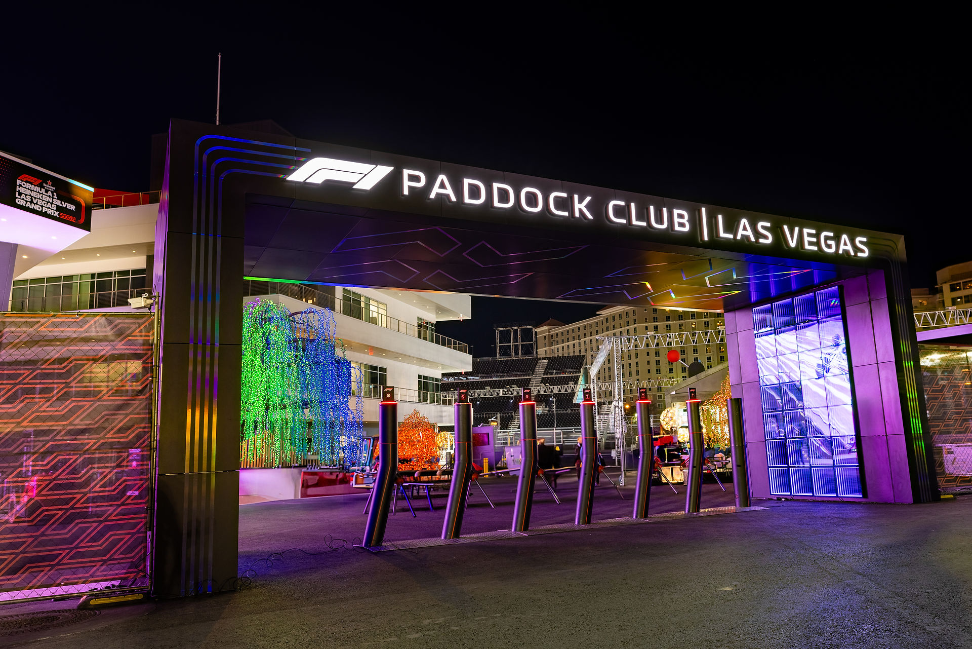 Nighttime view of the illuminated Paddock Club entrance at F1 Las Vegas.