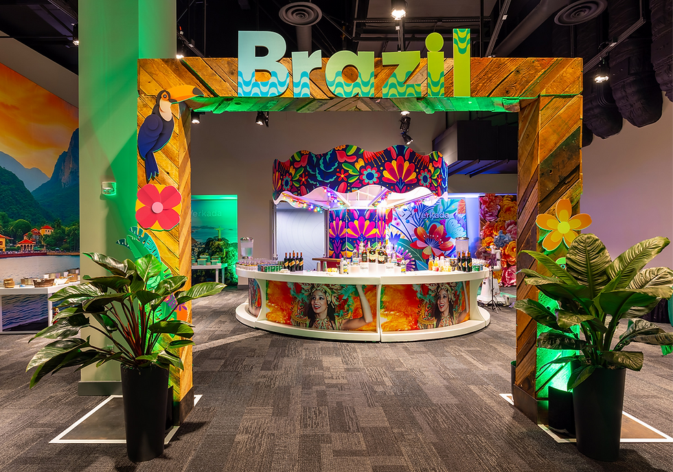 Colorful "Brazil" display with tropical decor, parrot, and flowers. Bar counter with drinks, vibrant backdrop, and potted plants. Lively mood.