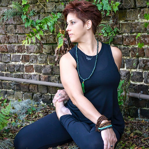 photo of Sara sitting in yoga pose
