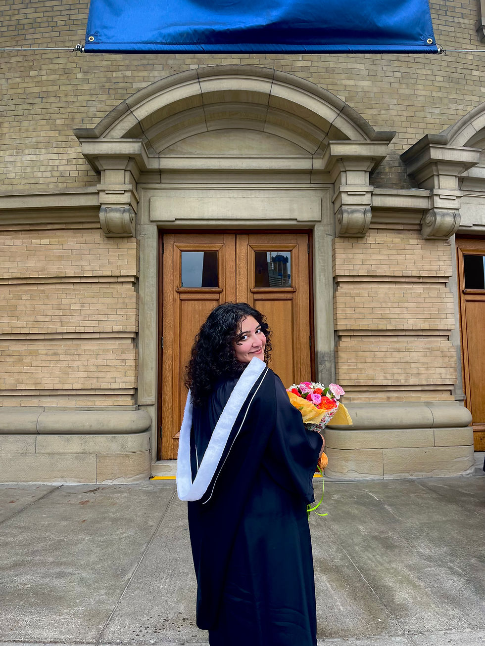 Melina at her University of Toronto graduation, wearing a cap and gown, holding a bouquet of flowers