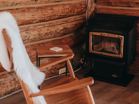 Cozy gas fireplace inside a log cabin at Wilder and Pine Riverside Cabins in Stevenson WA