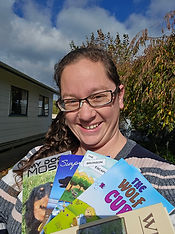 The author proudly showing off some of her books