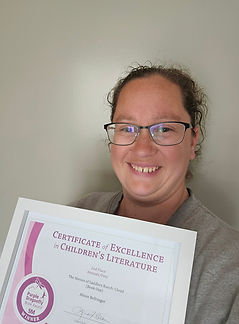 Author with a framed certificate