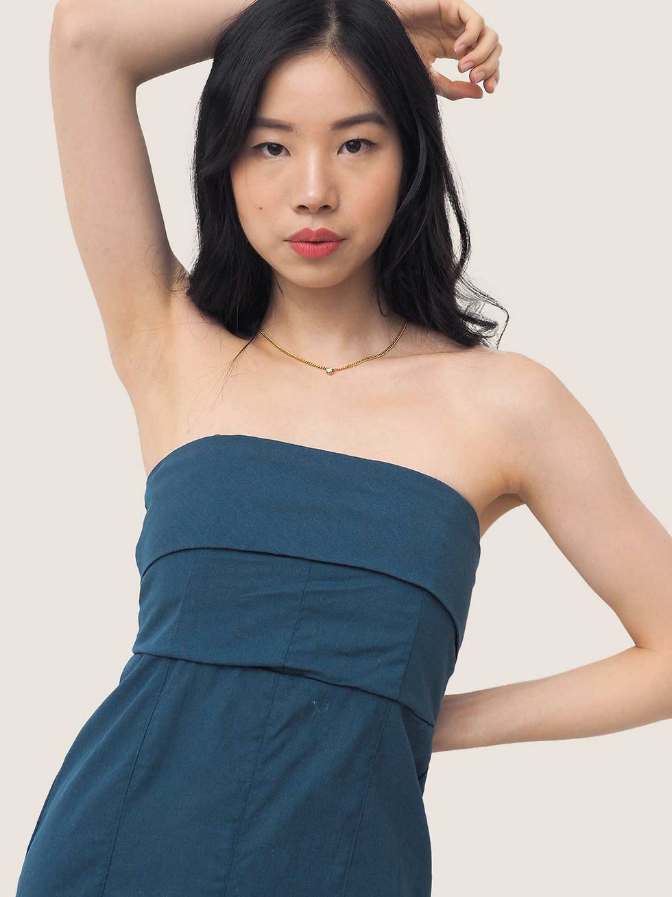 a model wearing a 3 in 1 stylish dress that you can style 3 different ways