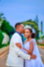 Groom kissing bride's forehead at wedding
