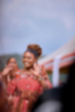 Smiling woman at a portfolio event waving her hands.