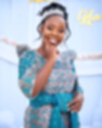 Smiling woman in traditional blue gomesi and tiara