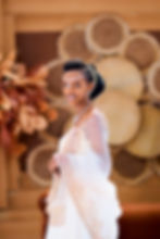Woman in traditional white dress and bridal headpiece.
