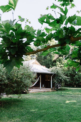 Garden-surrounded bungalow at our Anderson Valley boutique hotel with organic cotton hammock and shaded deck