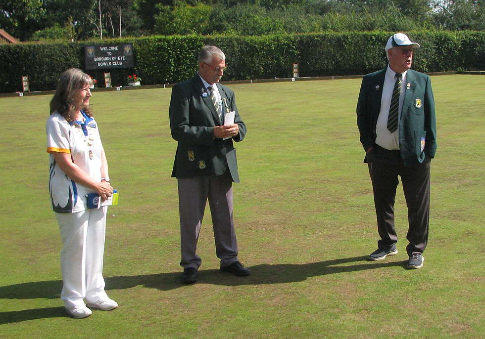 Borough of Eye BC president Ron Snell handing the green over to Ladies President Sue Bard-Bodek with Men's President Colin Hunting also in attendance