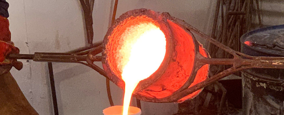 Pouring of liquid bronze at foundry