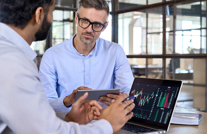 diverse-businessmen-traders-discussing-cryptocurrency-desk-using-devices.jpg