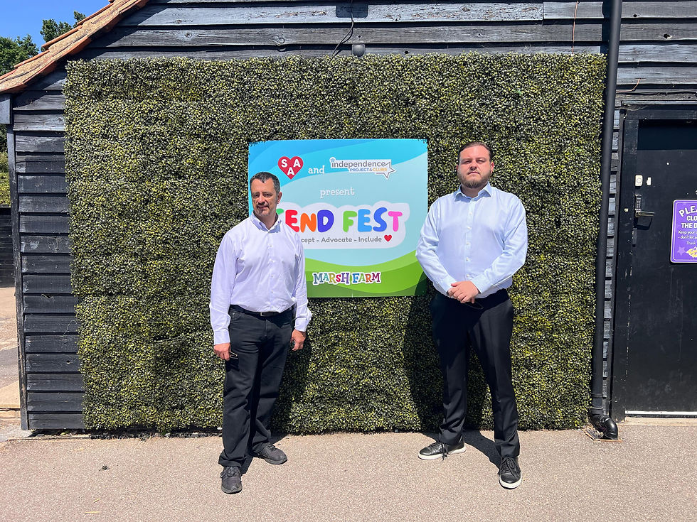 Two men in front of the SEND Fest sign.