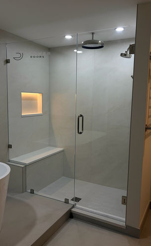 Custom frameless shower door installation with low iron glass and polished nickel hardware in South Florida