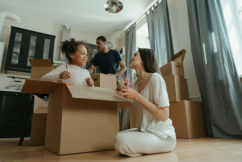 A man, woman, and child packing boxes.