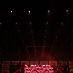 Dark anniversary stage illuminated by warm spotlights before the live show.