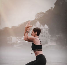 Yoga instructor Inge practicing Eagle Pose, improving balance and concentration in a serene setting."
