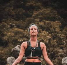 meditating in a peaceful retreat setting with nature in the background.