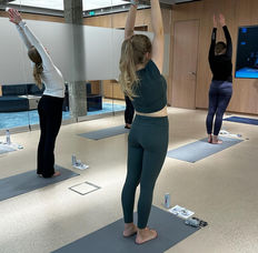 Business professionals enjoying a guided workplace yoga session, enhancing team cohesion and mental well-being Amsterdam Almere Rotterdam
