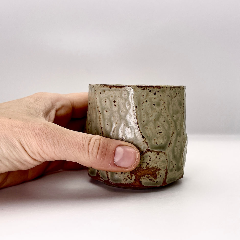 Thumbnail: Faceted cup in wood ash glaze