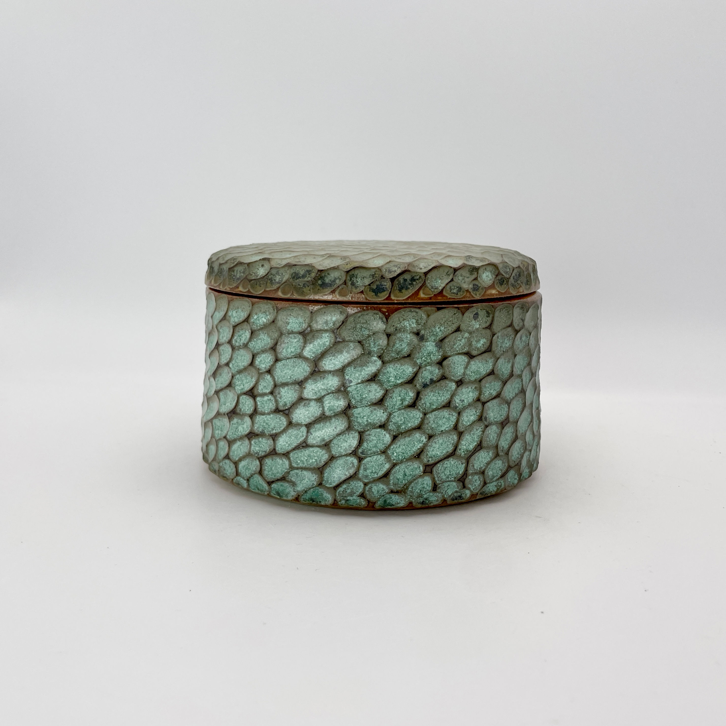 Carved pot in weathered green