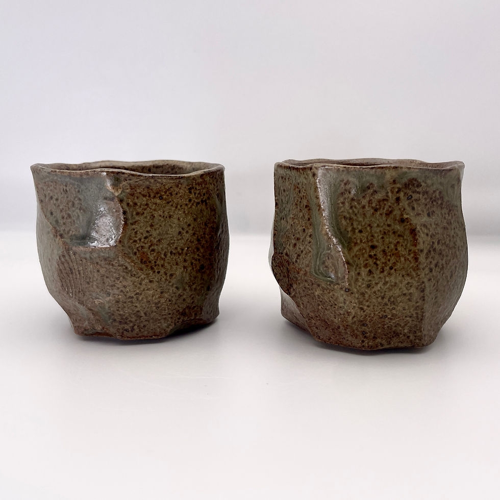Thumbnail: Faceted cup in dark wood ash glaze