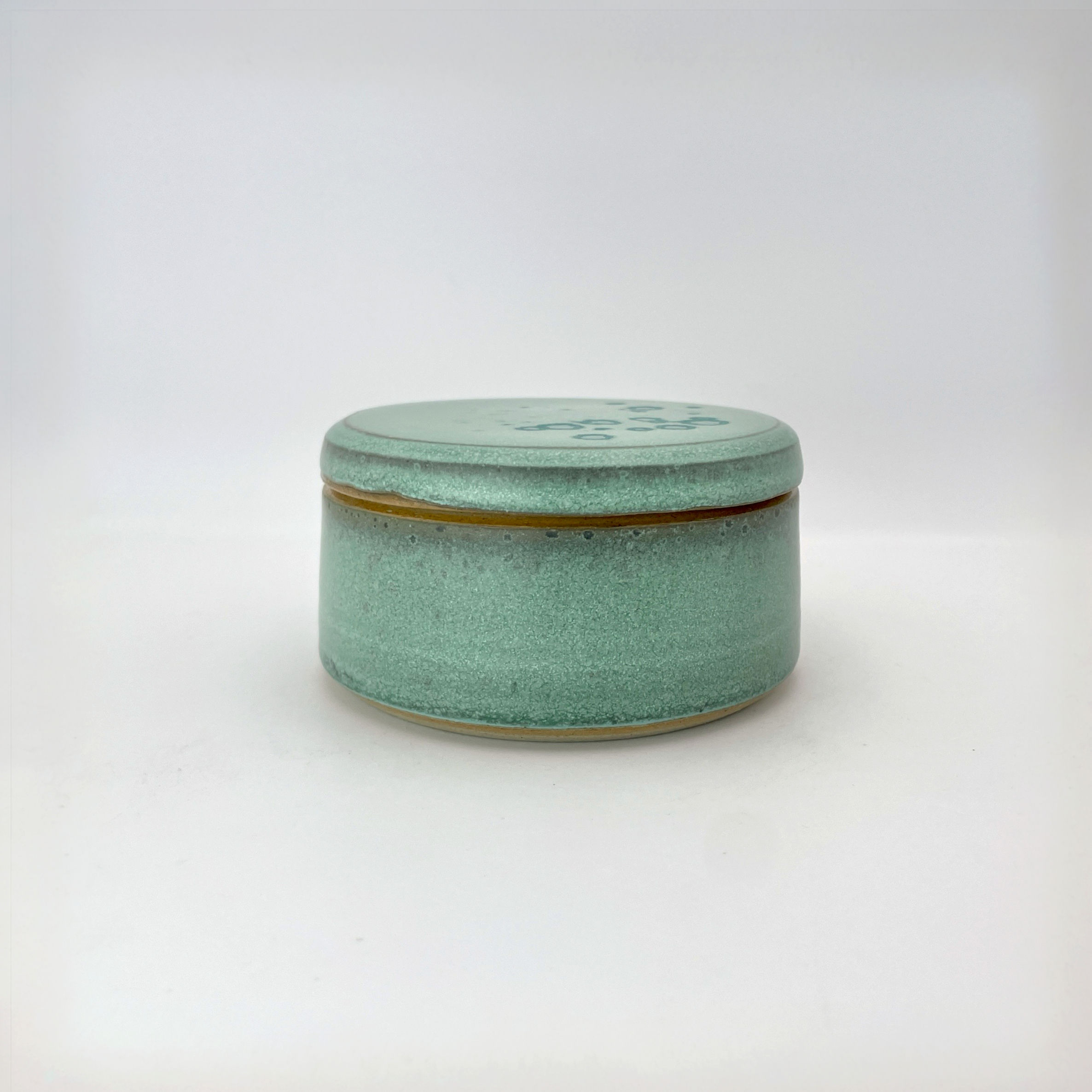 Lidded pot in soft green with turquoise
