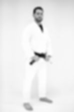Pedro Araújo wearing a white gi and a black t-shirt in Trein Fort Bend in Sugar Land, TX, USA. He has dark hair slicked back and a well-groomed dark beard.