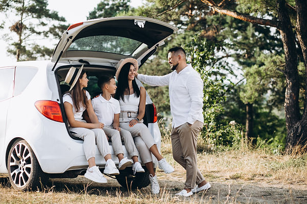 parents-with-their-children-on-car-in-the-field.jpeg