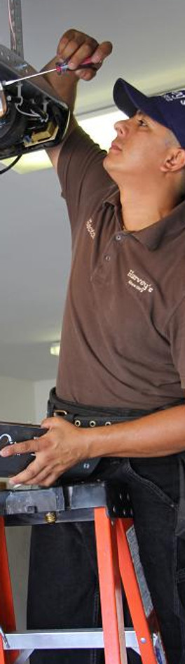 Harvey's Garage Door employee installing a garage door motor