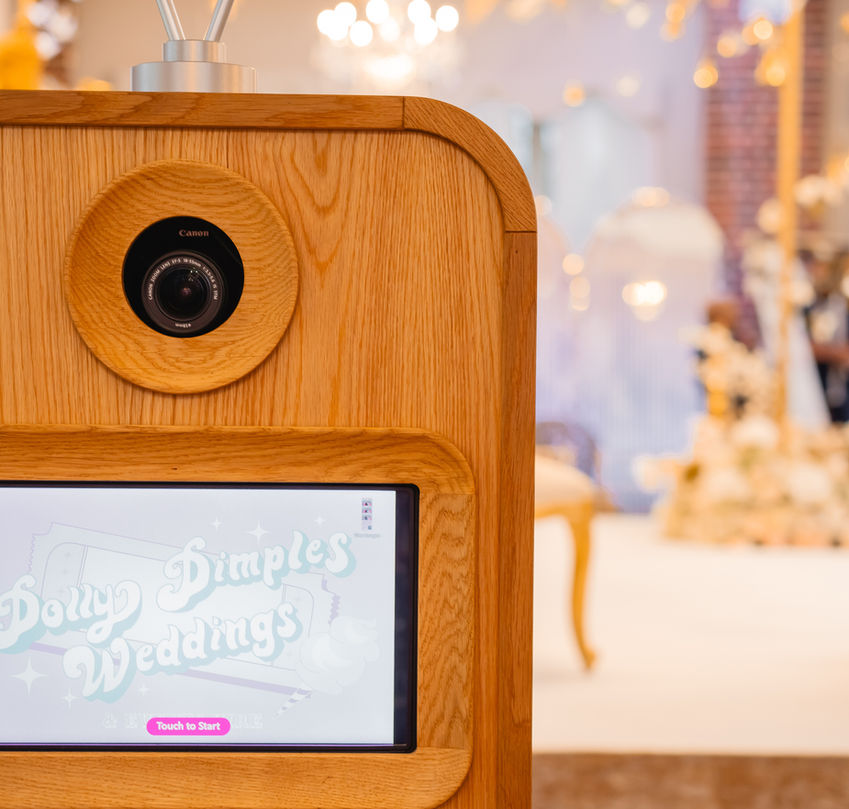 Photo booth with classic wooden exterior and digital interface, designed for seamless photo fun at Hertfordshire wedding celebrations.