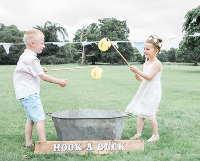 Rustic Hook a Duck game setup for garden game hire, providing fun and nostalgic entertainment for guests.