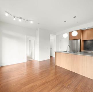Modern kitchen with full-size appliances and efficient layout in a Coquitlam condo.