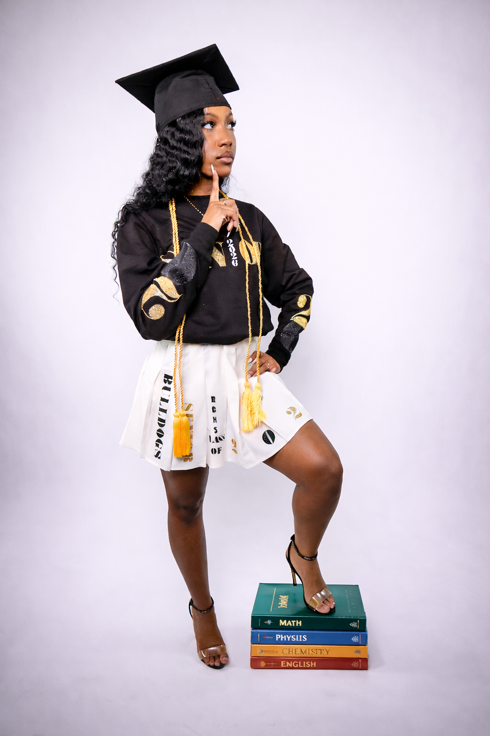 Graduation pose with stacked textbooks.png