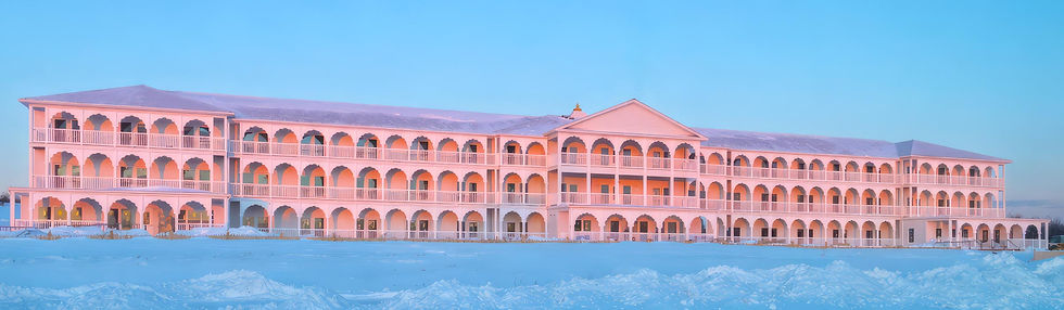 Warm sunrise light illuminates the east facade of the Maharishi Vastu® building in Livings