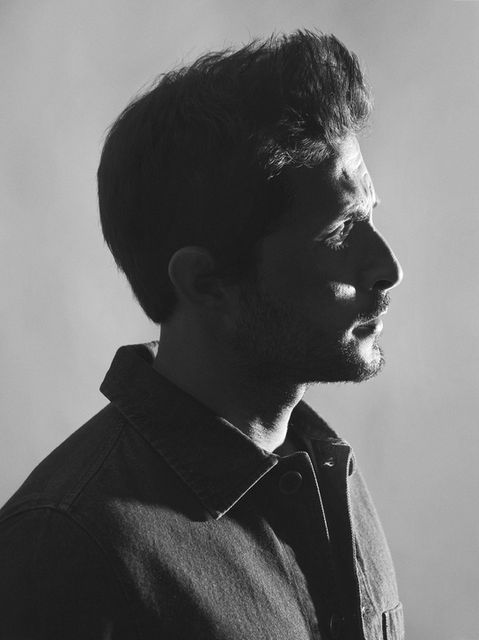 A black and white portrait of Tomer Capone with hard light shot in a studio by Liron Weissman