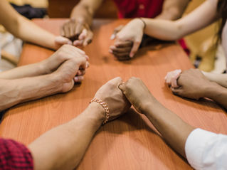 people holding hands at table https://www.magnific.com/