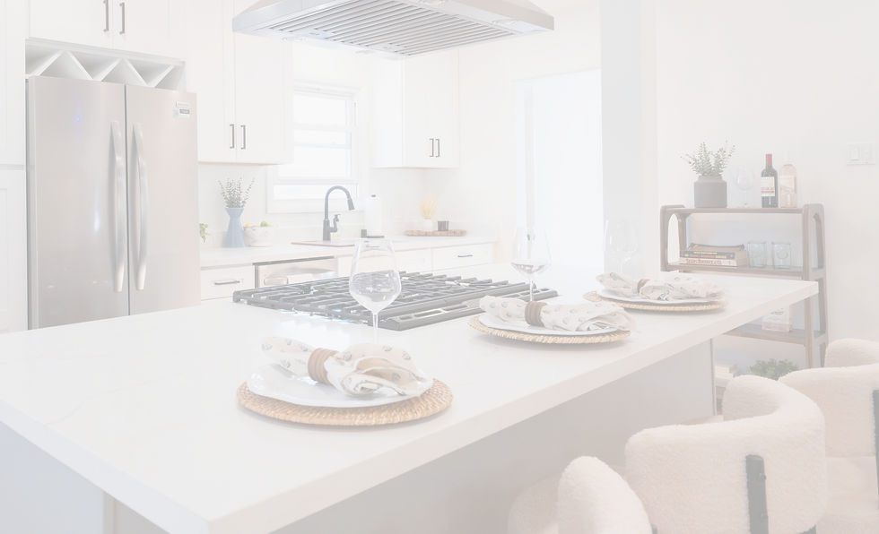 Countertop with counter height bar stools and coastal vibe table settings in front of a modern light kitchen.