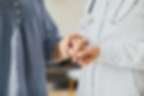 female doctor holding elderly patients hands